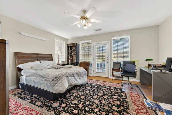 a bedroom with a large bed and a window