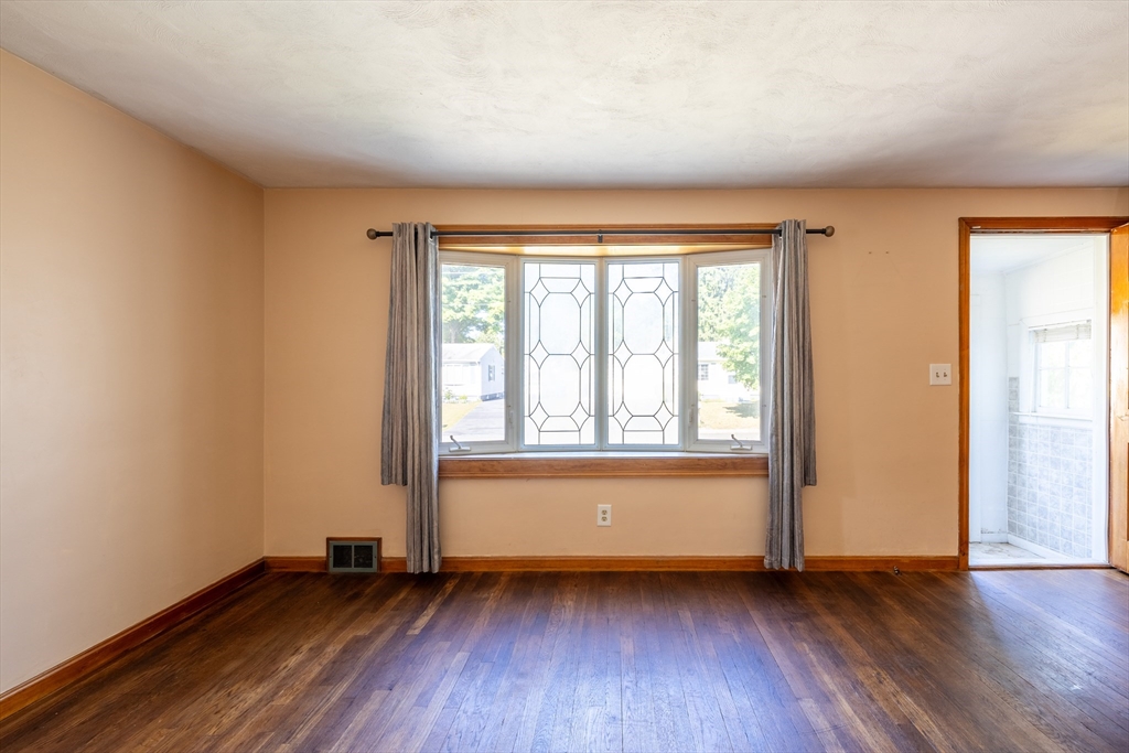 19 Redden Road Springfield, MA 01119 - Photo 11 of 33 an empty room with wooden floor and windows