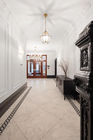 a living room with furniture a wooden floor and a ceiling fan