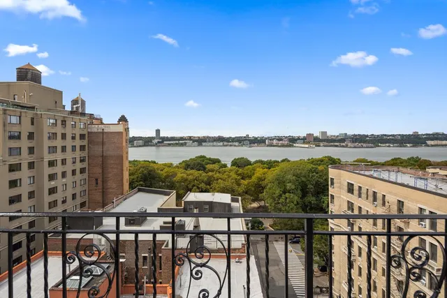 a view of a balcony with wooden floor and city view