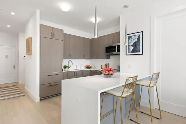 a kitchen with a sink cabinets and appliances