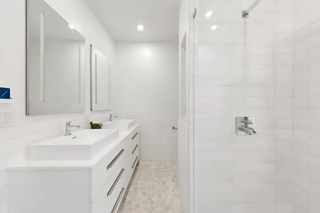 a large bed sitting in a bedroom next to a window with wooden floor