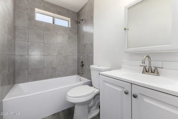 a bathroom with a sink a toilet and bathtub