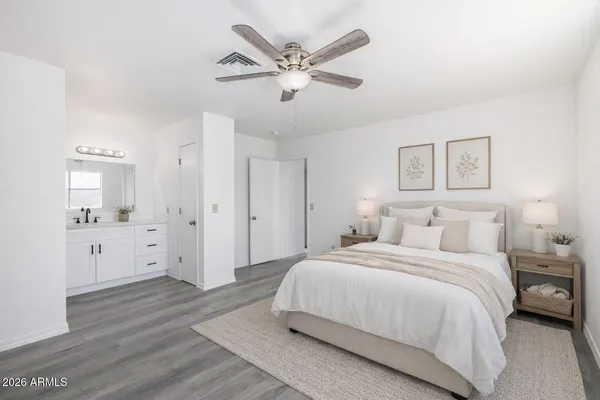 a bedroom with a large bed and white walls