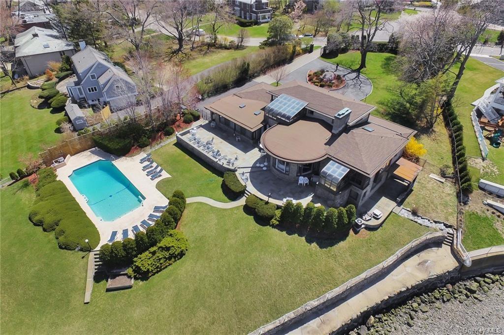 an aerial view of a swimming pool patio yard and outdoor seating