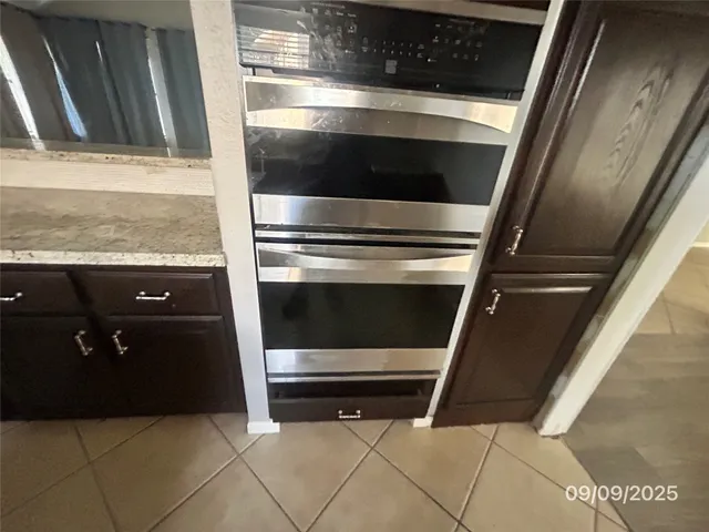 a stove top oven sitting inside of a kitchen