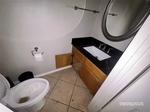 a bathroom with a toilet a sink and mirror