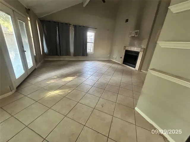 a view of a livingroom with an empty space and a fireplace