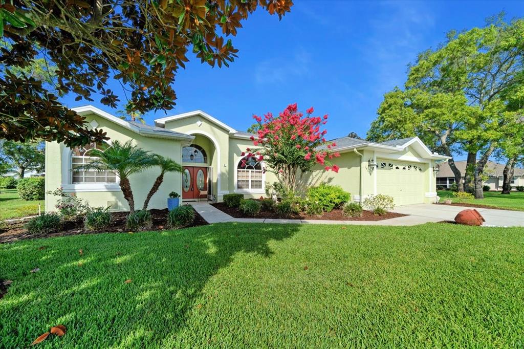 a front view of a house with a yard and garage