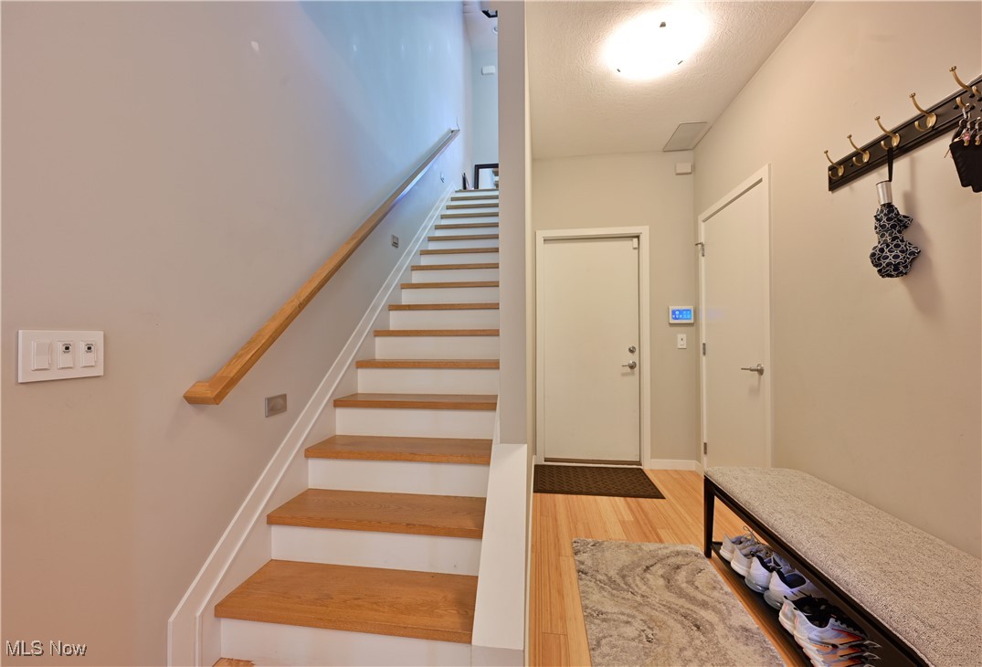 18875 Riversouth Fairview Park, Unit 30 Cleveland, OH 44126 - Photo 13 of 39 Stairs with wood finished floors and a textured ceiling