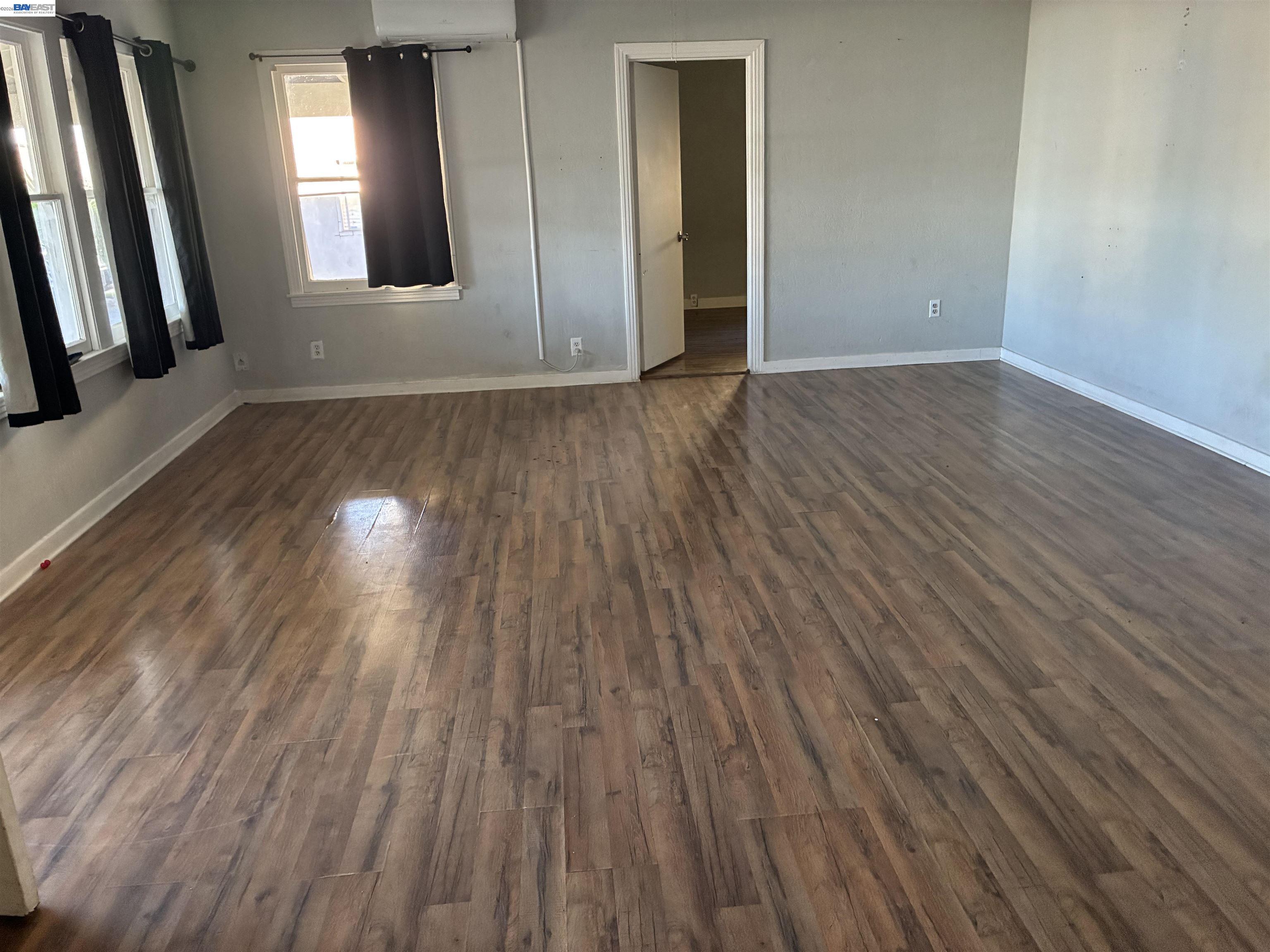 1614 Mono Drive Modesto, CA 95354 - Photo 6 of 15 a view of an empty room with wooden floor and a window