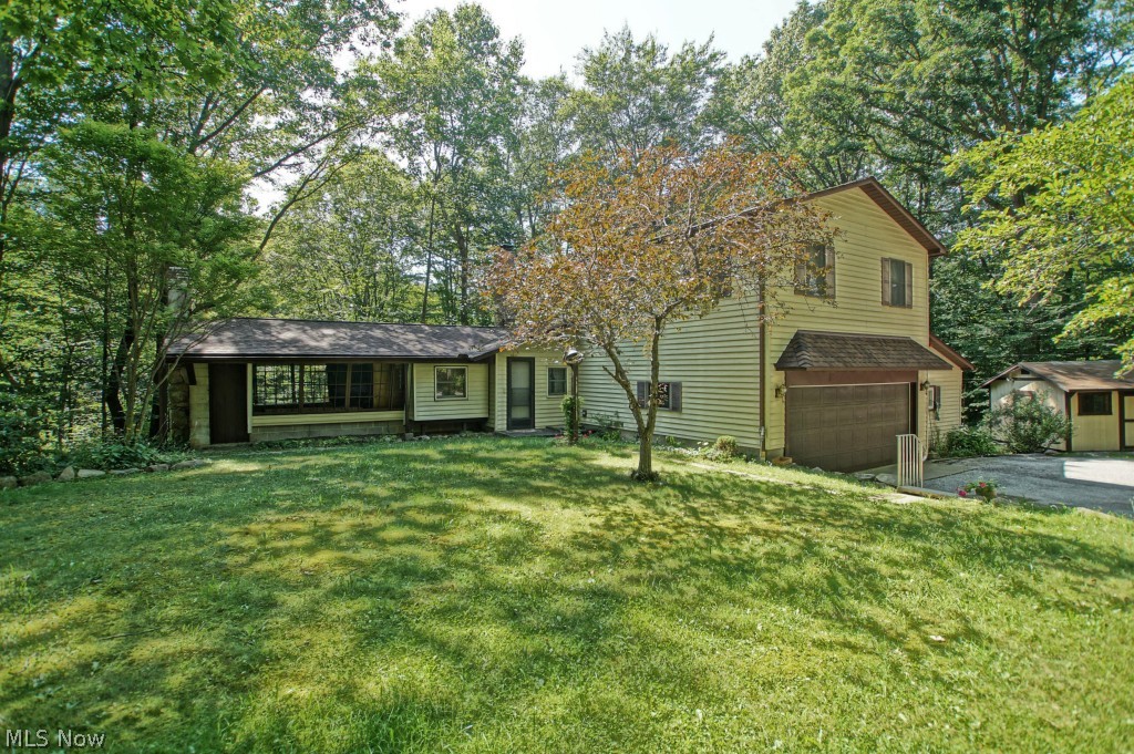 12154 Concord Hambden Road Painesville, OH 44077 - Photo 1 of 25 Charming & unique. Sunroom to the left is great spot for enjoying nature & the serenity of this property.