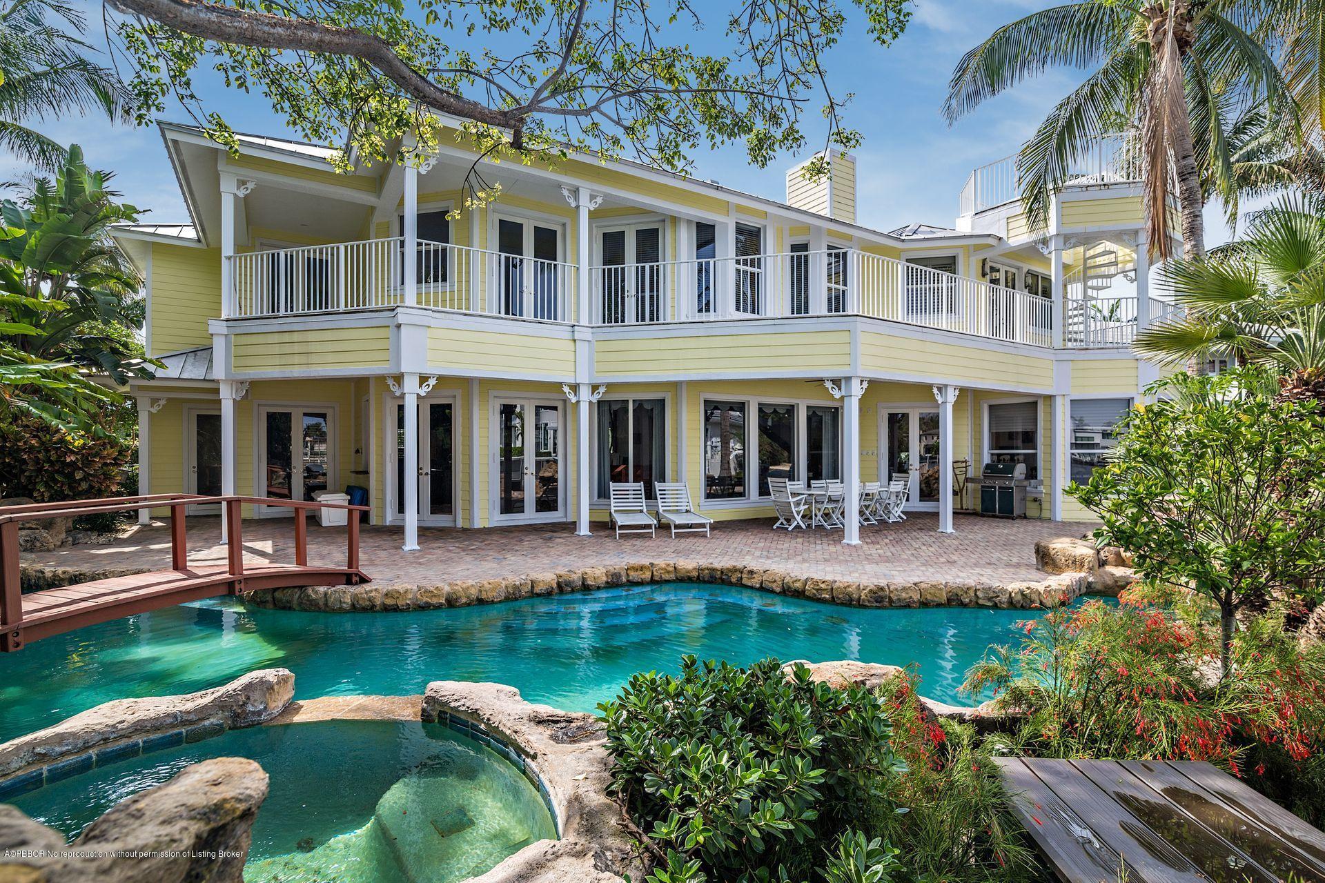 1121 Marble Way Boca Raton, FL 33432 - Photo 3 of 44 a front view of a house with swimming pool and garden
