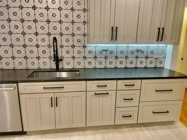 a view of a yard with plants and a large tree