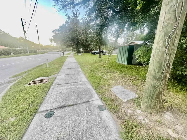 a view of a house with a yard and a fence