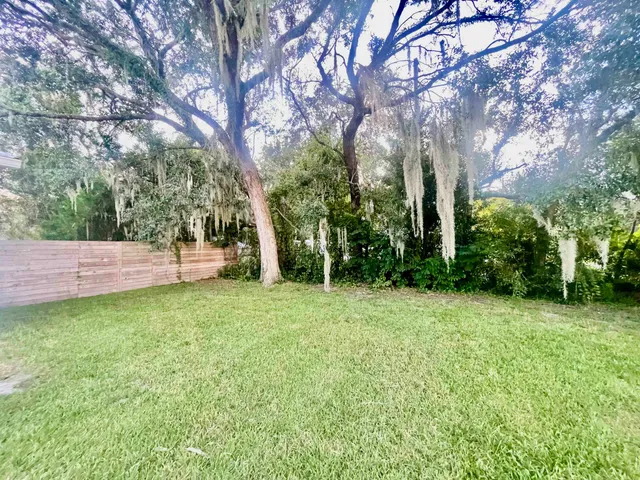 a view of a house with a yard and sitting area