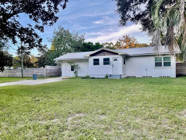 a front view of house with yard and green space