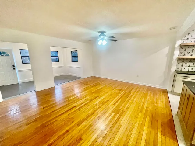 a view of a hallway with wooden floor