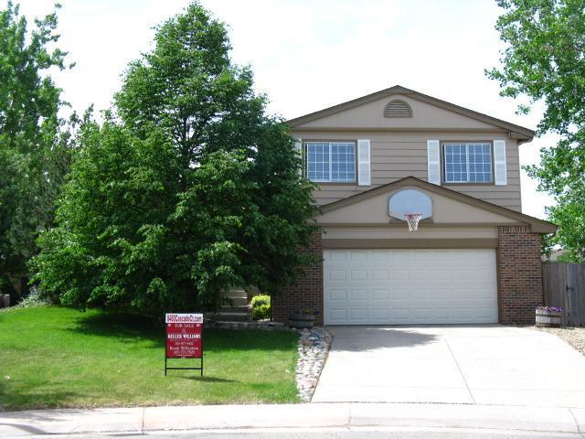 8480 Cascade Court Highlands Ranch, CO 80126 - Photo 1 of 1 a front view of a house with a yard