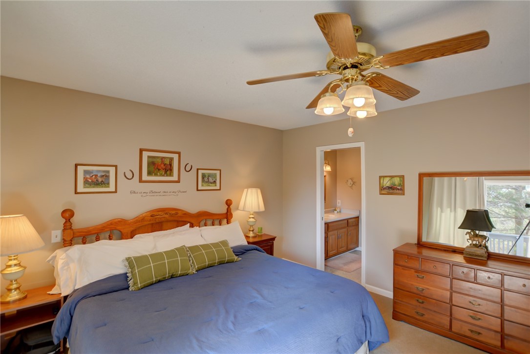 4095 West Rock Springs Road Decatur, IL 62522 - Photo 12 of 48 a bedroom with a bed and wooden floor