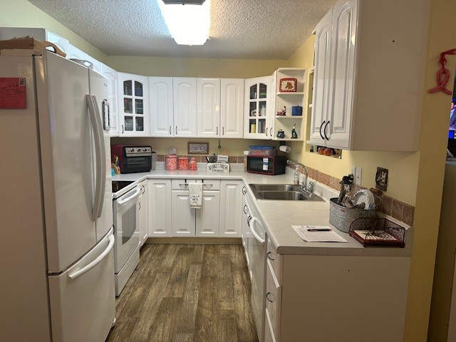 5693 Snow Creek Road Santa Fe, TN 38482 - Photo 8 of 30 a room with a refrigerator a sink and cabinets