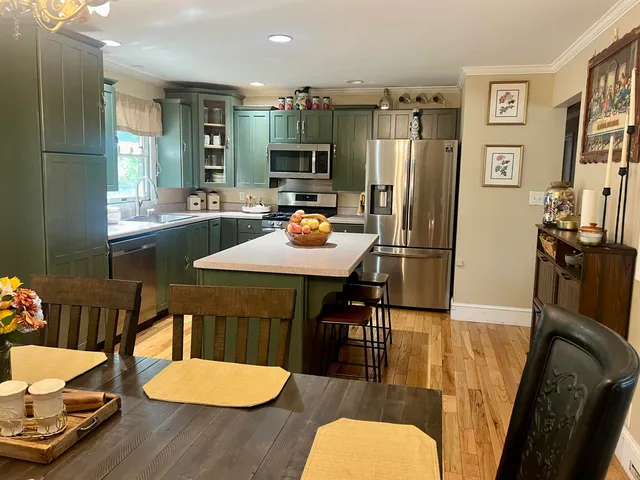 a living room with a bed and a mirror