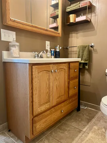 a view of a bedroom with cabinets and window