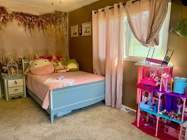 a bedroom with a bed and window