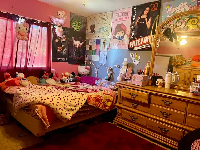 a bed sitting in a bedroom and painting on the wall