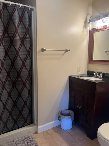 an empty room with windows and cabinet