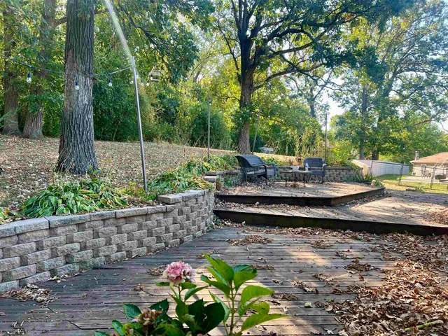 a view of a house with a yard and tree s