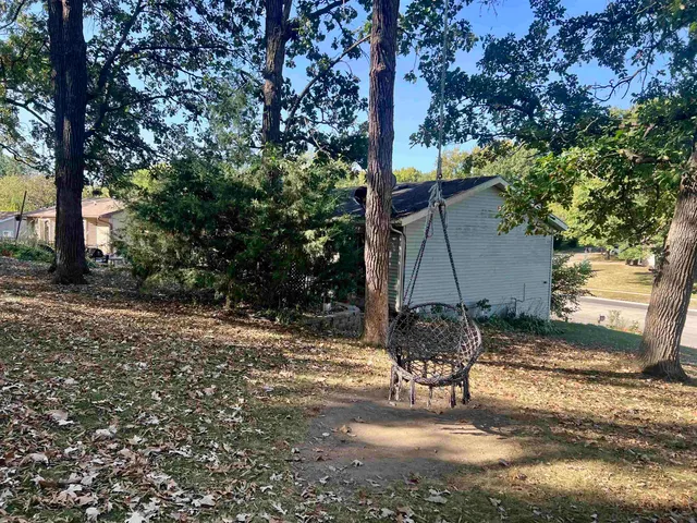 a view of a house with a backyard and sitting area
