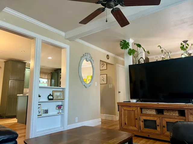 a kitchen with stainless steel appliances a stove a sink a microwave a refrigerator and chairs