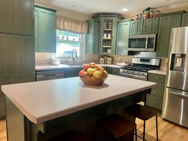 a kitchen with a table chairs and wooden floor