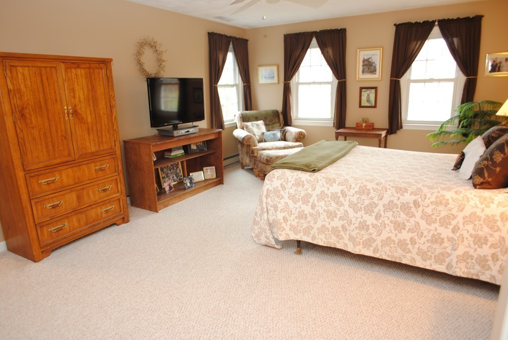 61 Blanchard Road Boxborough, MA 01719 - Photo 14 of 27 a bedroom with a bed and a flat screen tv