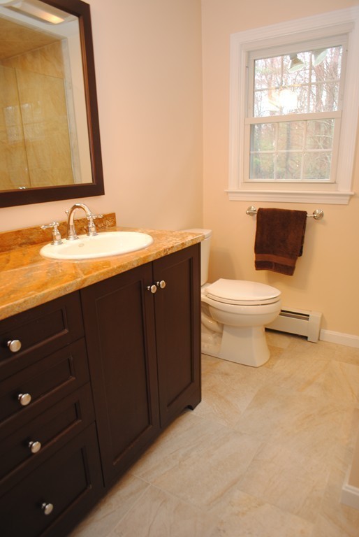 61 Blanchard Road Boxborough, MA 01719 - Photo 17 of 27 a bathroom with a granite countertop toilet a sink and a mirror