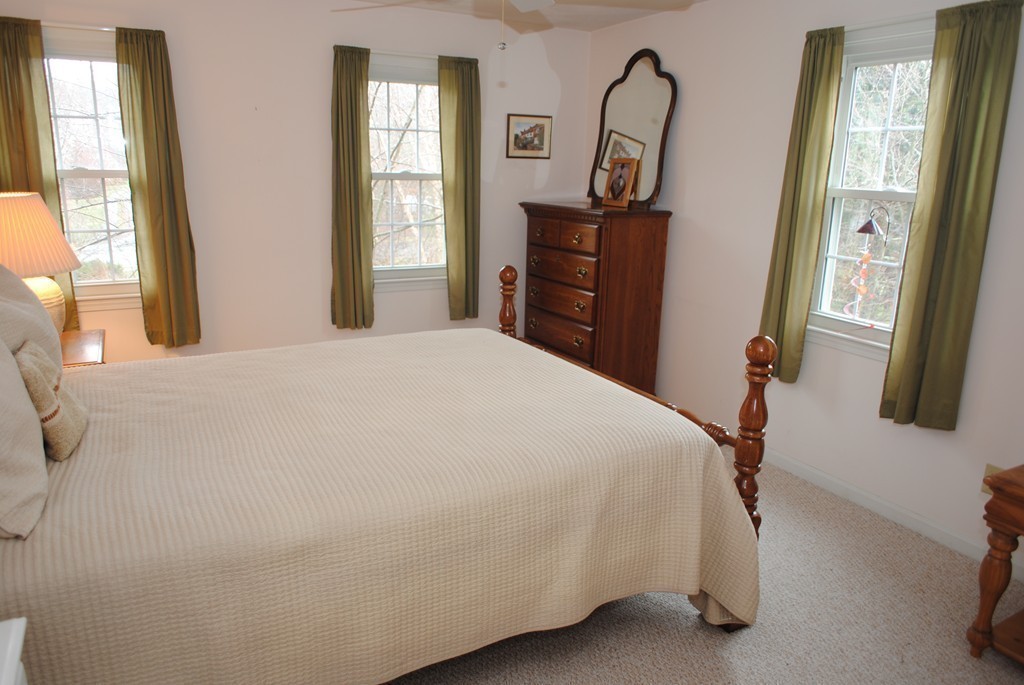 61 Blanchard Road Boxborough, MA 01719 - Photo 19 of 27 a bedroom with a bed window and mirror