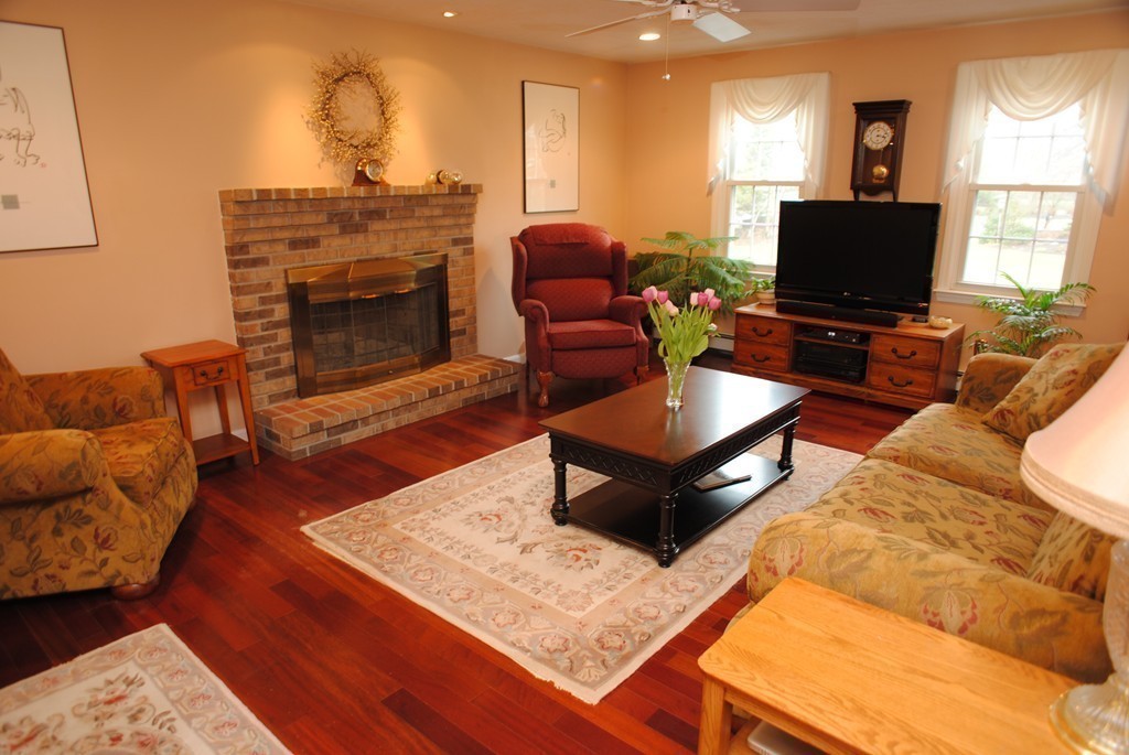 61 Blanchard Road Boxborough, MA 01719 - Photo 6 of 27 a living room with furniture a flat screen tv and a fireplace