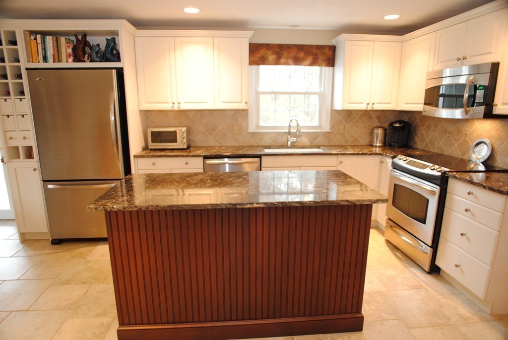 61 Blanchard Road Boxborough, MA 01719 - Photo 9 of 27 a kitchen with stainless steel appliances granite countertop a refrigerator a sink a stove a counter space and cabinets