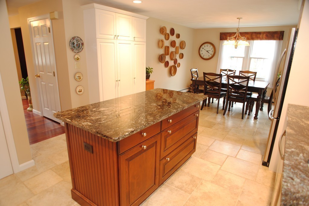 61 Blanchard Road Boxborough, MA 01719 - Photo 10 of 27 an open kitchen with a table and a large window