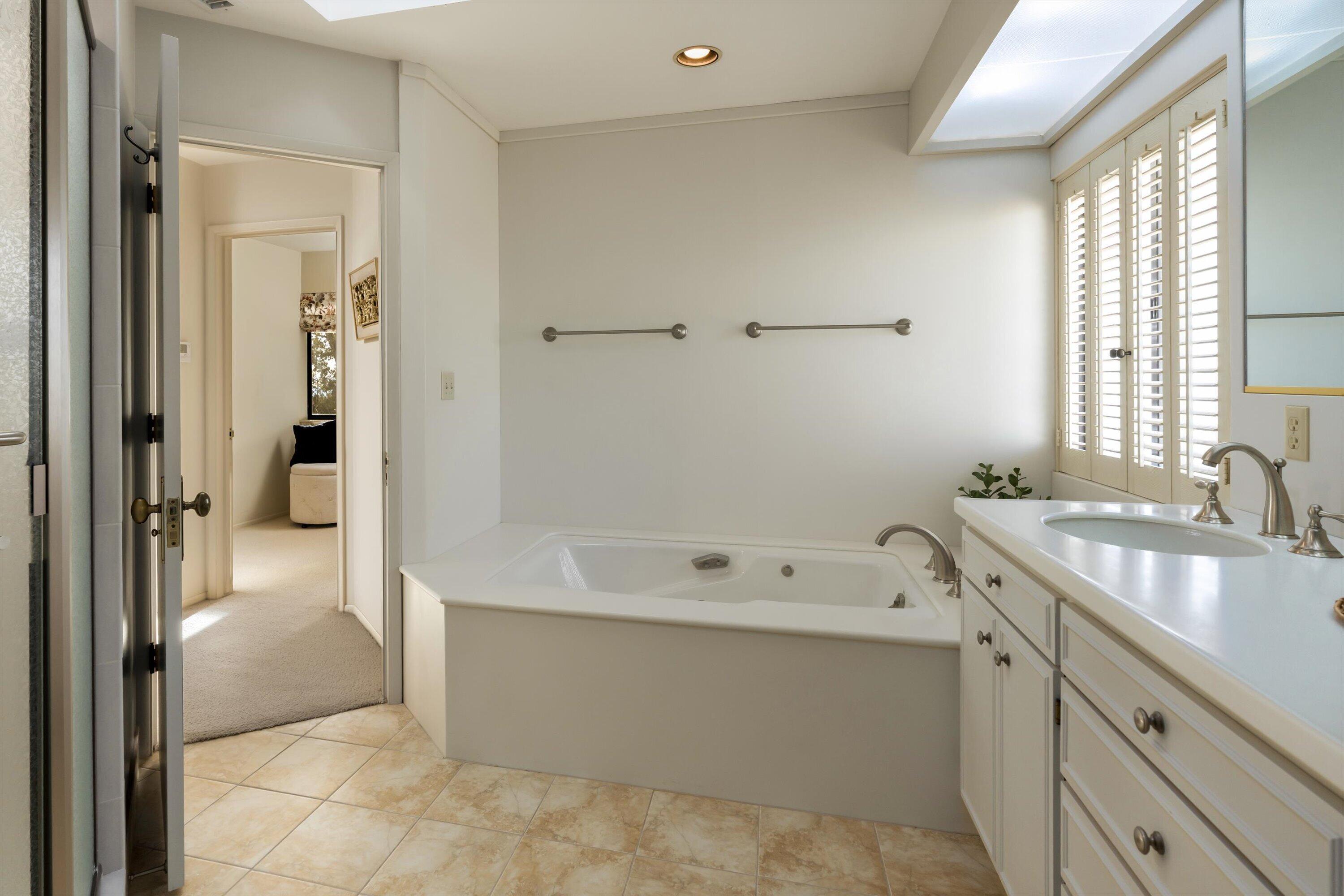 3940 Foothill Road Ventura, CA 93003 - Photo 27 of 49 a bathroom with a tub sink and mirror