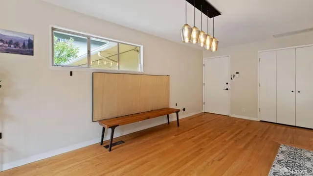 a view of room with window and wooden floor