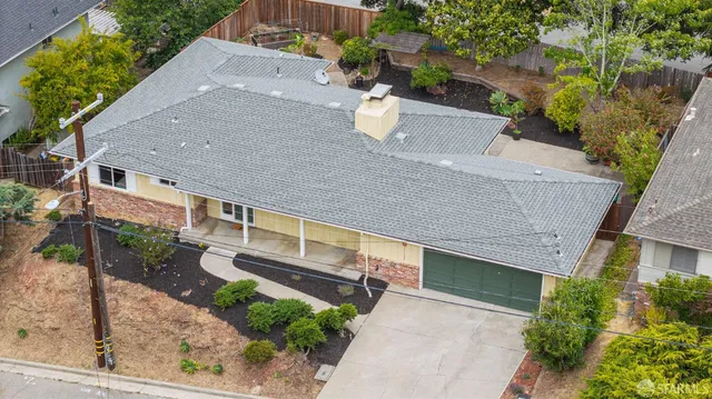 an aerial view of a house with a yard