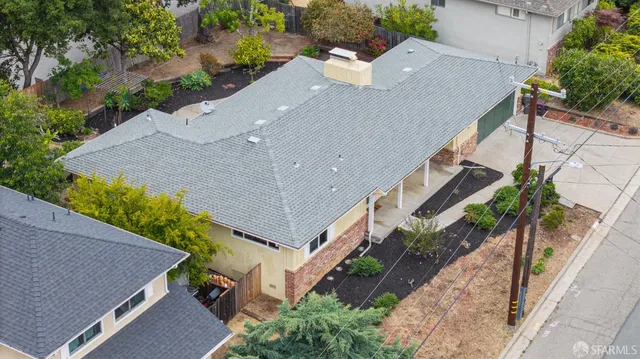 an aerial view of a house with a yard and a wooden fence