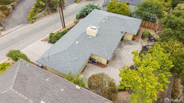an aerial view of a house with a yard