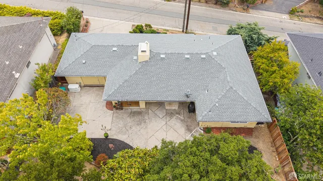 an aerial view of a house with a yard