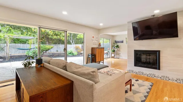 a living room with fireplace furniture and a flat screen tv