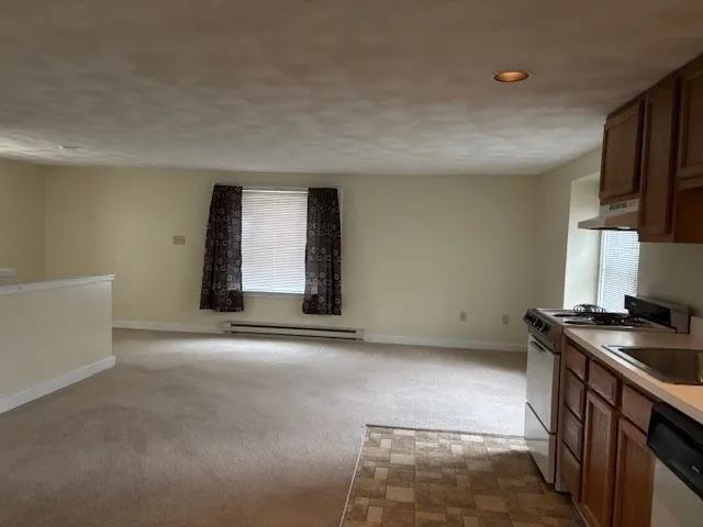 a view of kitchen with stainless steel appliances granite countertop a stove a sink and a refrigerator