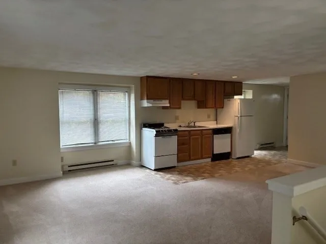 a kitchen with stainless steel appliances a stove and a refrigerator