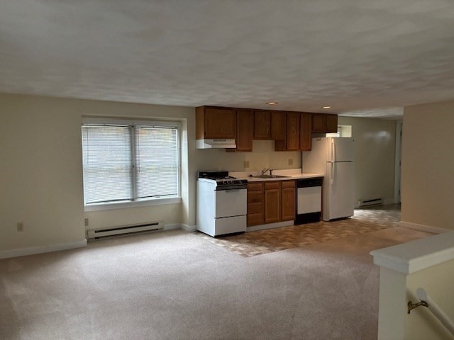 17A Maywood Lane, Unit C Woburn, MA 01801 - Photo 6 of 11 a kitchen with stainless steel appliances a stove and a refrigerator